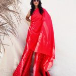 Fiery red asymmetrical kurti in art silk and sharara pants in cotton brocade with polka dots.