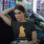 crop-top-tee-mockup-being-worn-by-a-girl-lying-on-the-arcade-car-games-a19440